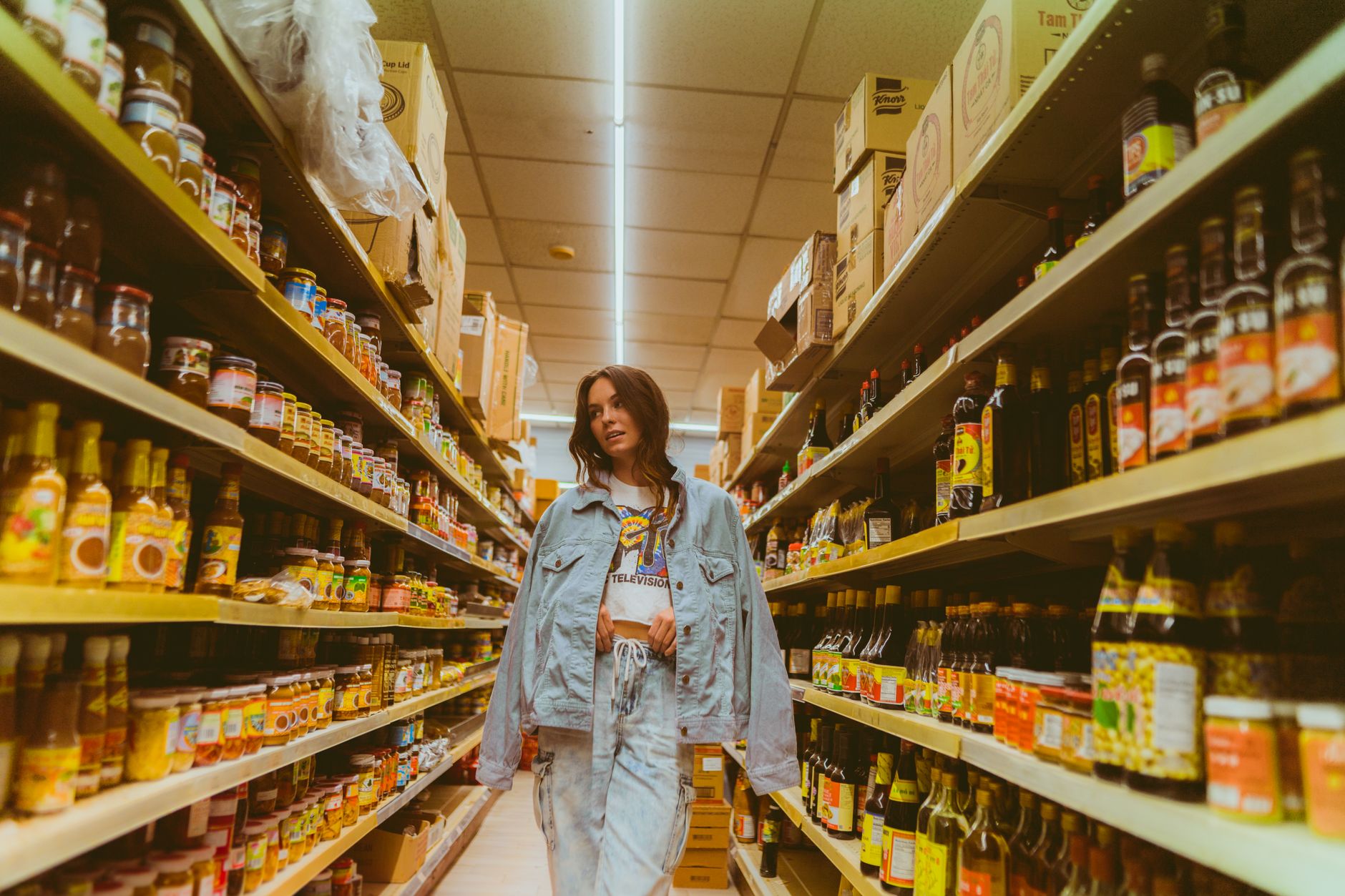 Shopper browsing a grocery store aisle