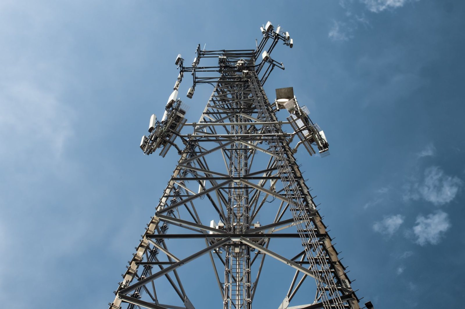Mobile phone network tower against a blue sky