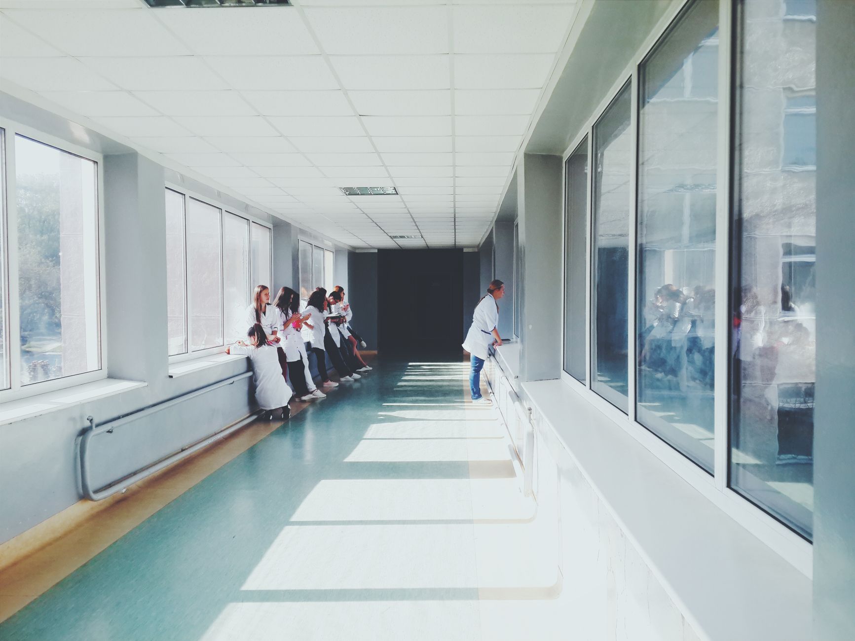Bright hospital hallway with medical staff