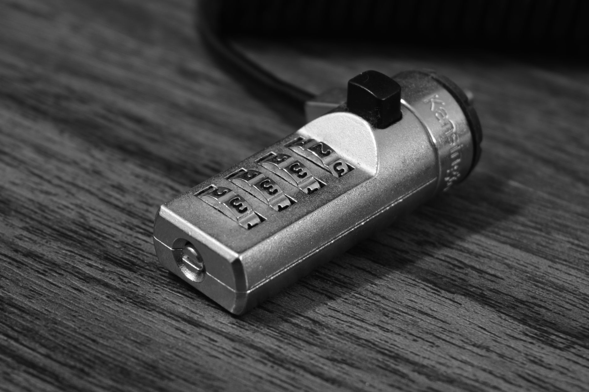 Metal combination lock on a wooden surface