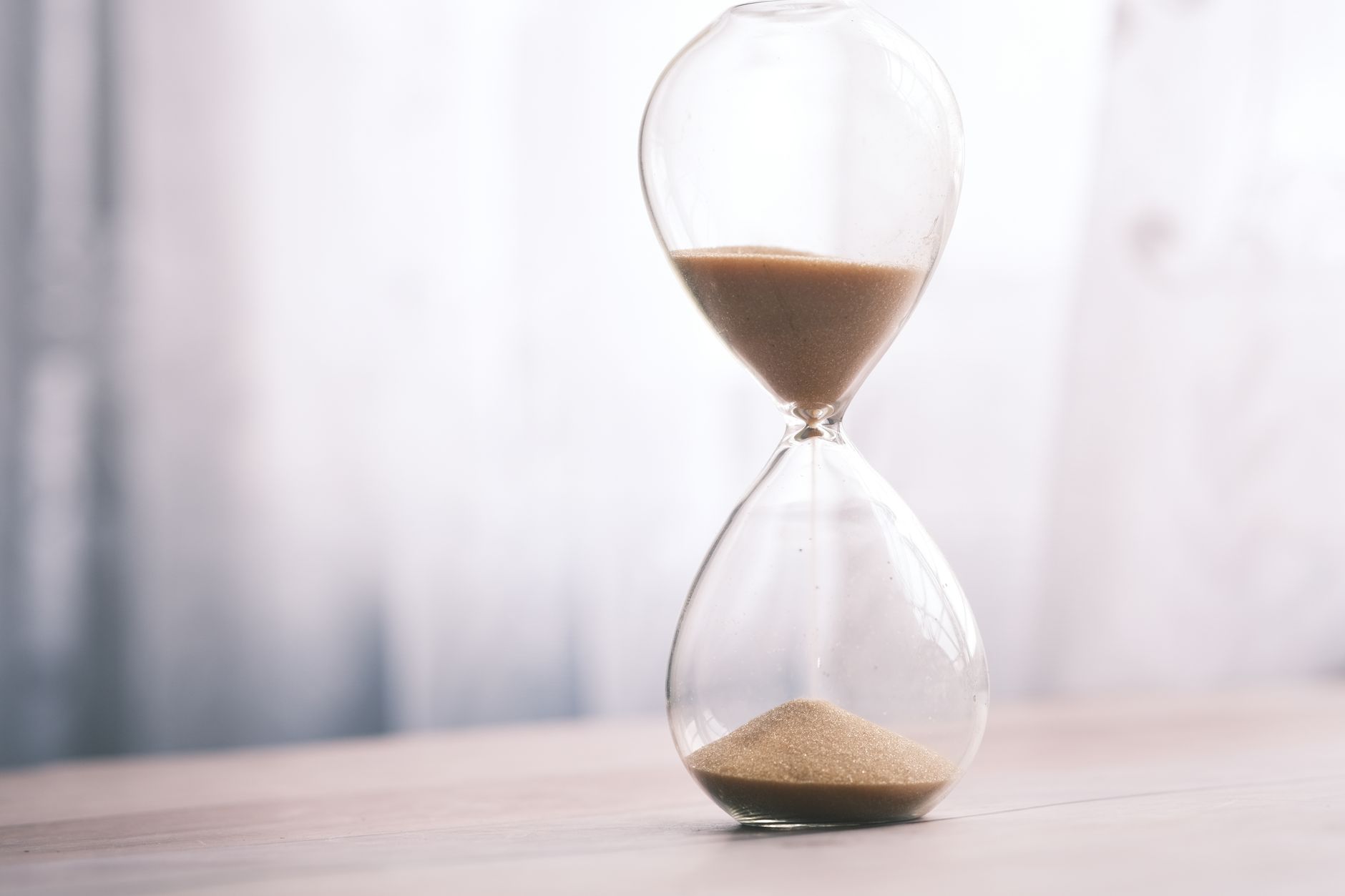 Hourglass with sand running through it